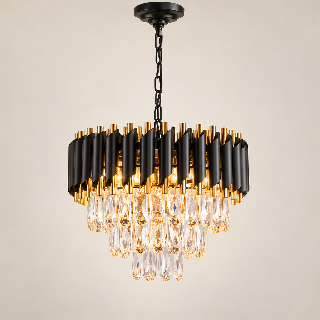 Aurevon 3-tier black and gold crystal chandelier, lit, on a greige studio background