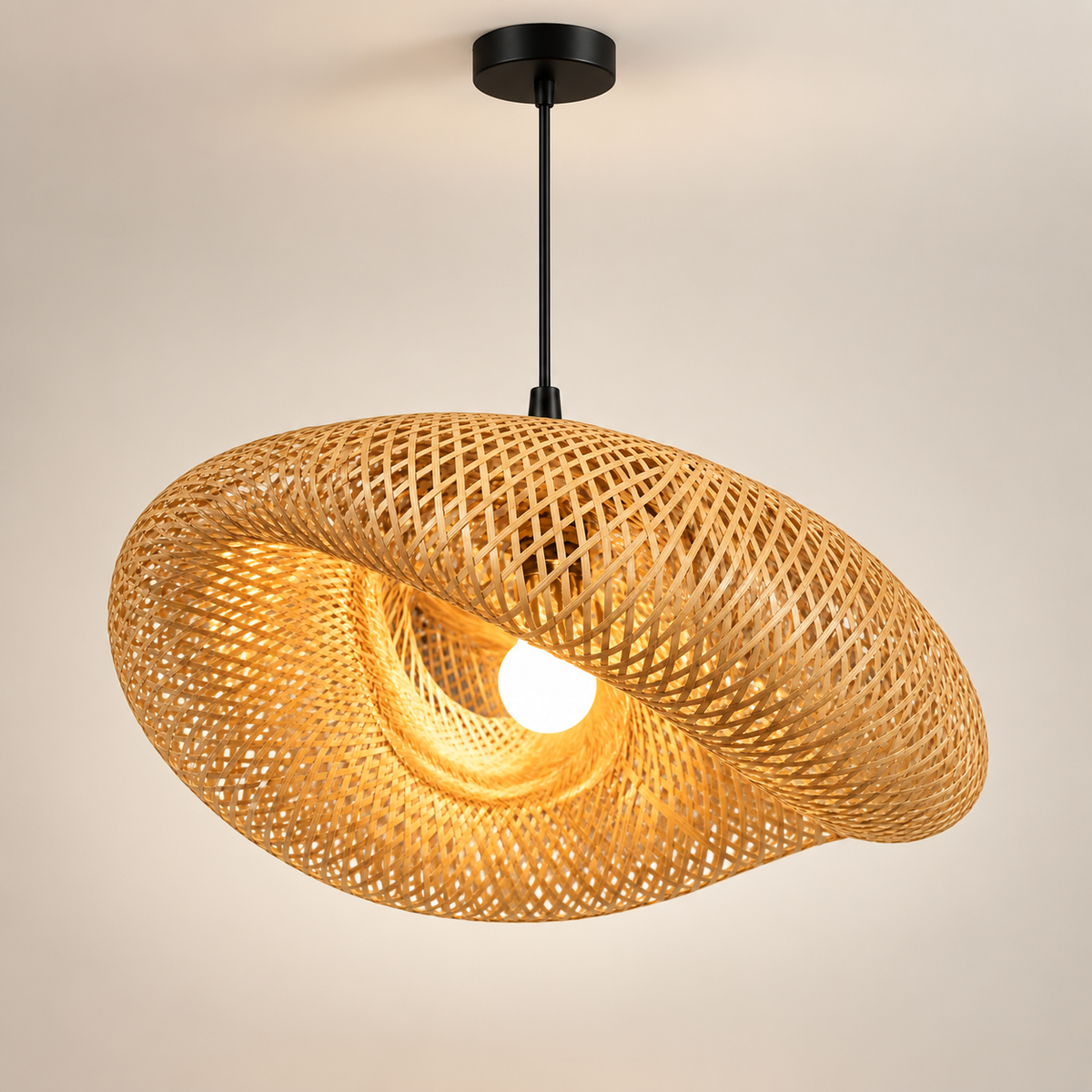 Avelora bamboo pendant light, hand-woven wave shade, lit, on a greige studio background