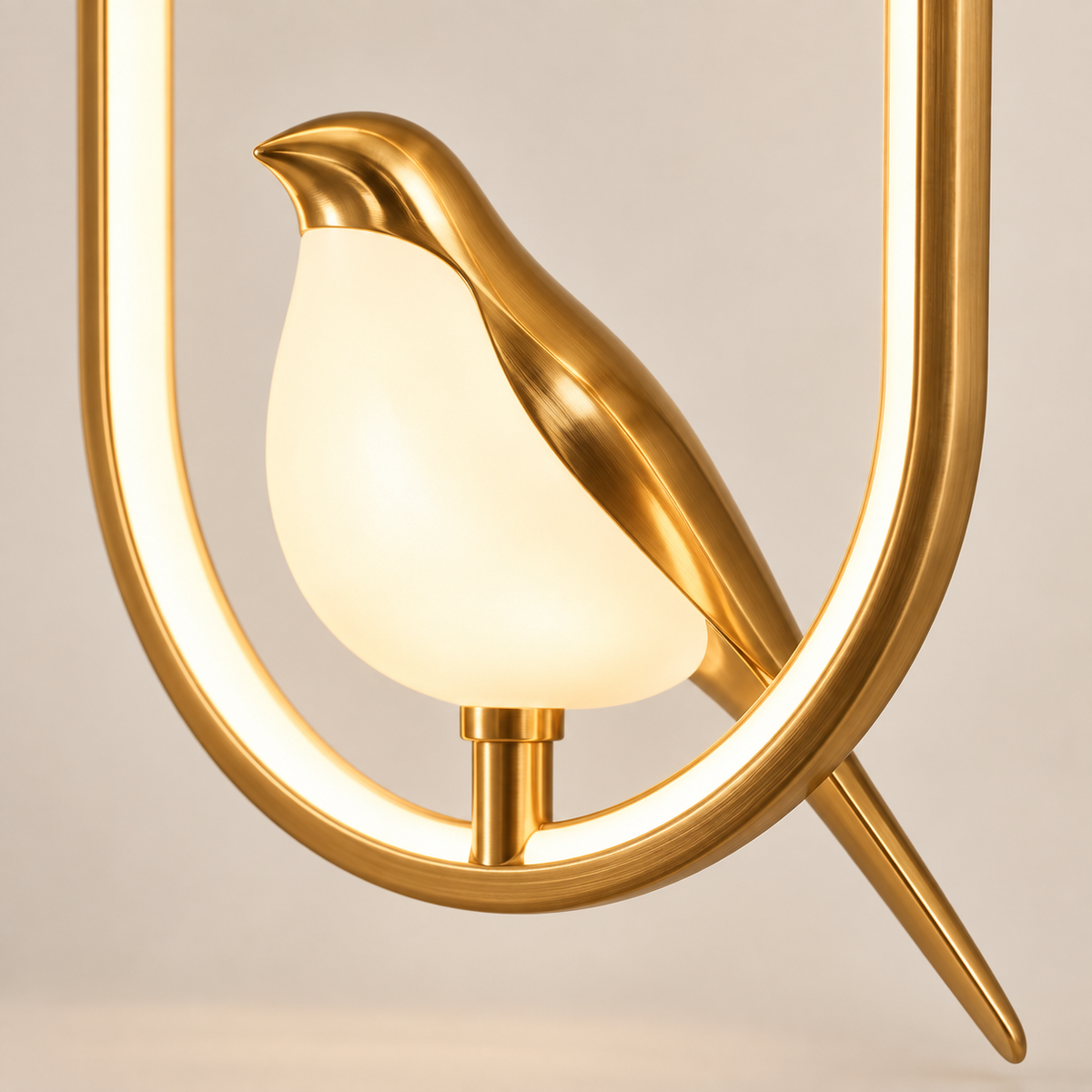 Close-up of the Aviora glowing acrylic bird on its gold oval frame