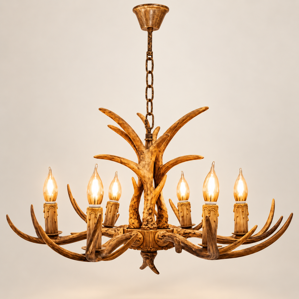 Cervara 6-light antler chandelier, lit, on a greige studio background