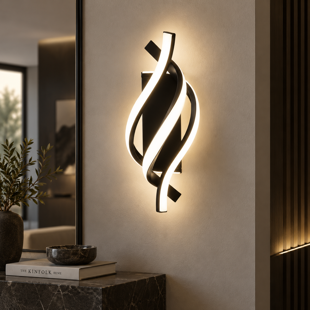 Elara sculptural LED wall light in black, lit on a living room wall