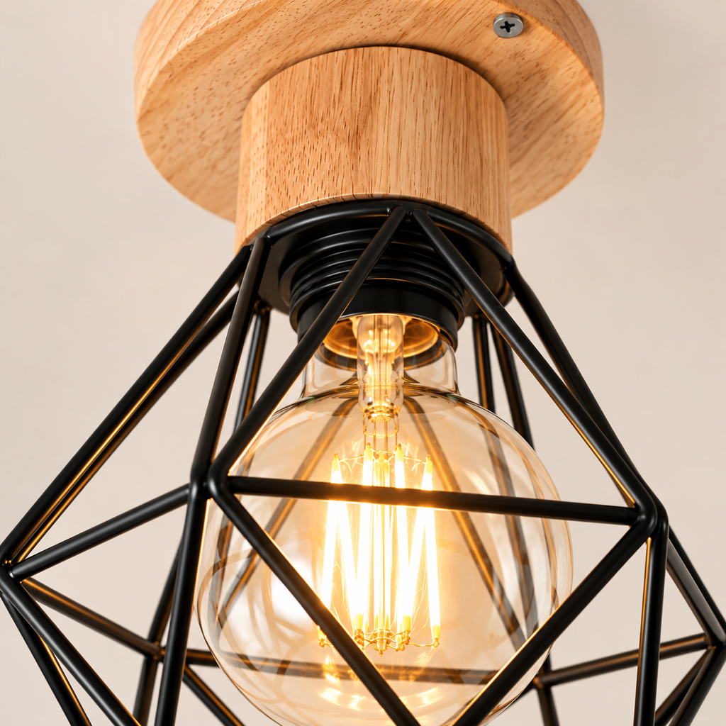 Close-up of the Ferro faceted black cage, filament bulb and wooden base