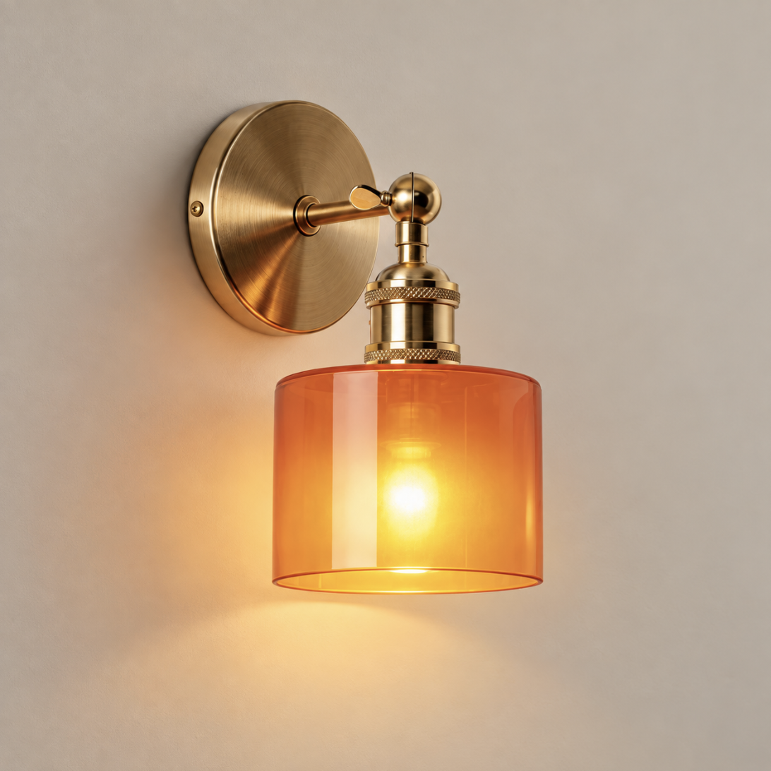 Ines cordless rechargeable amber glass wall light in brass, lit, on a greige wall