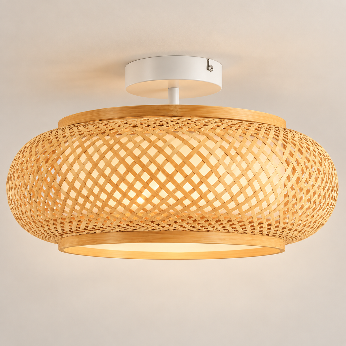 Kora hand-woven bamboo drum ceiling light, lit, on a greige studio background