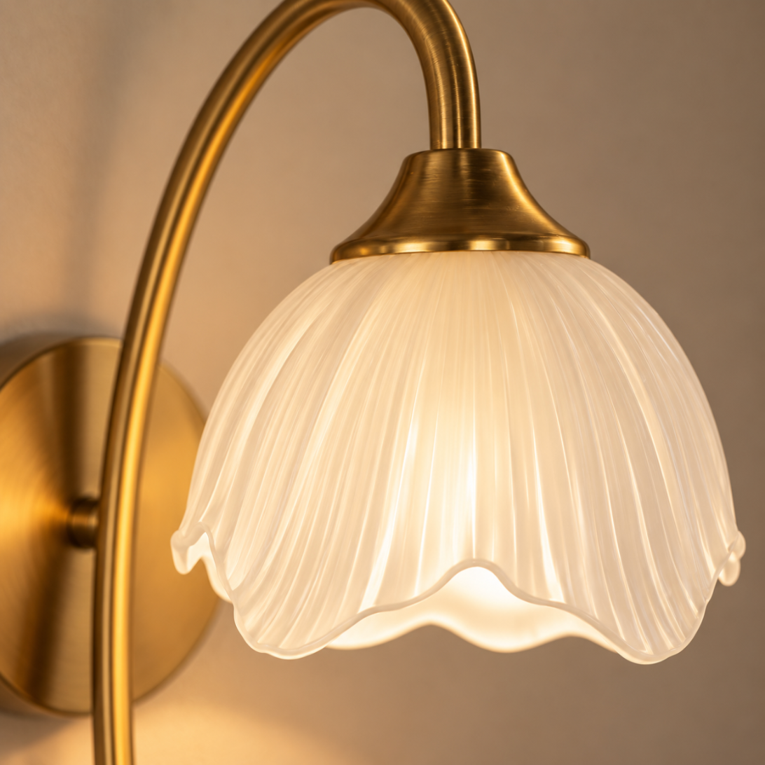 Close-up of the Liora frosted fluted petal shade and brushed gold arm