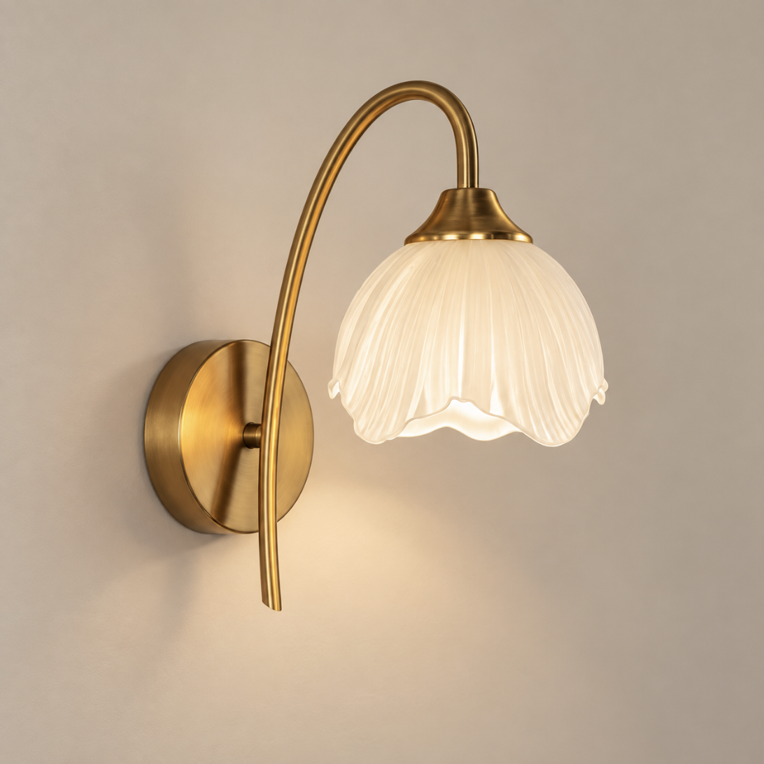 Liora cordless rechargeable petal wall light in gold, lit, on a greige wall