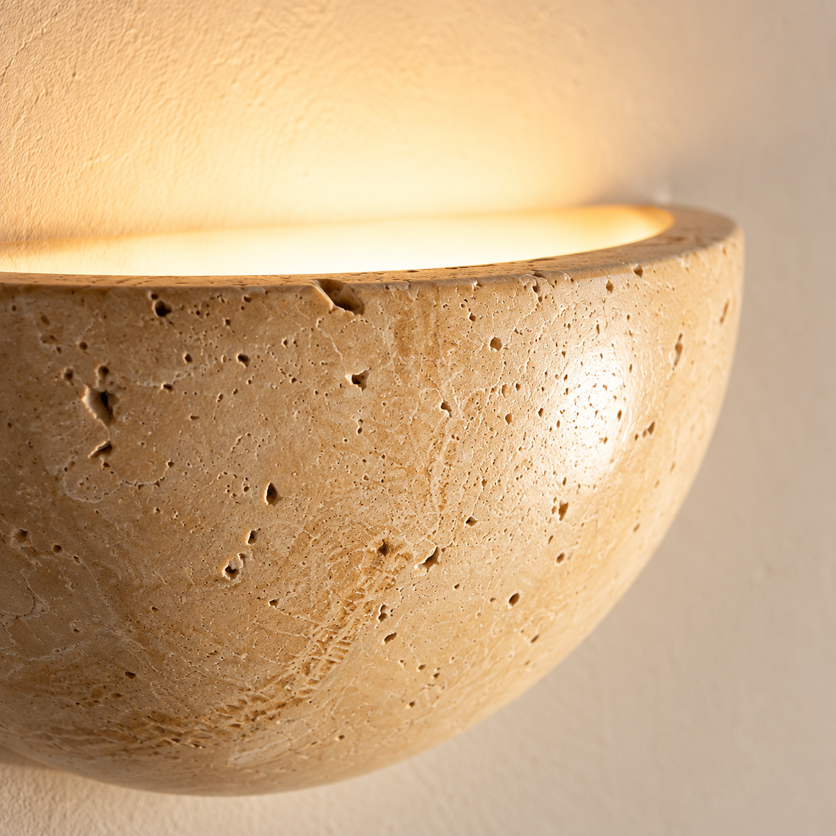 Close-up of the Lunara's natural travertine pores and warm glow