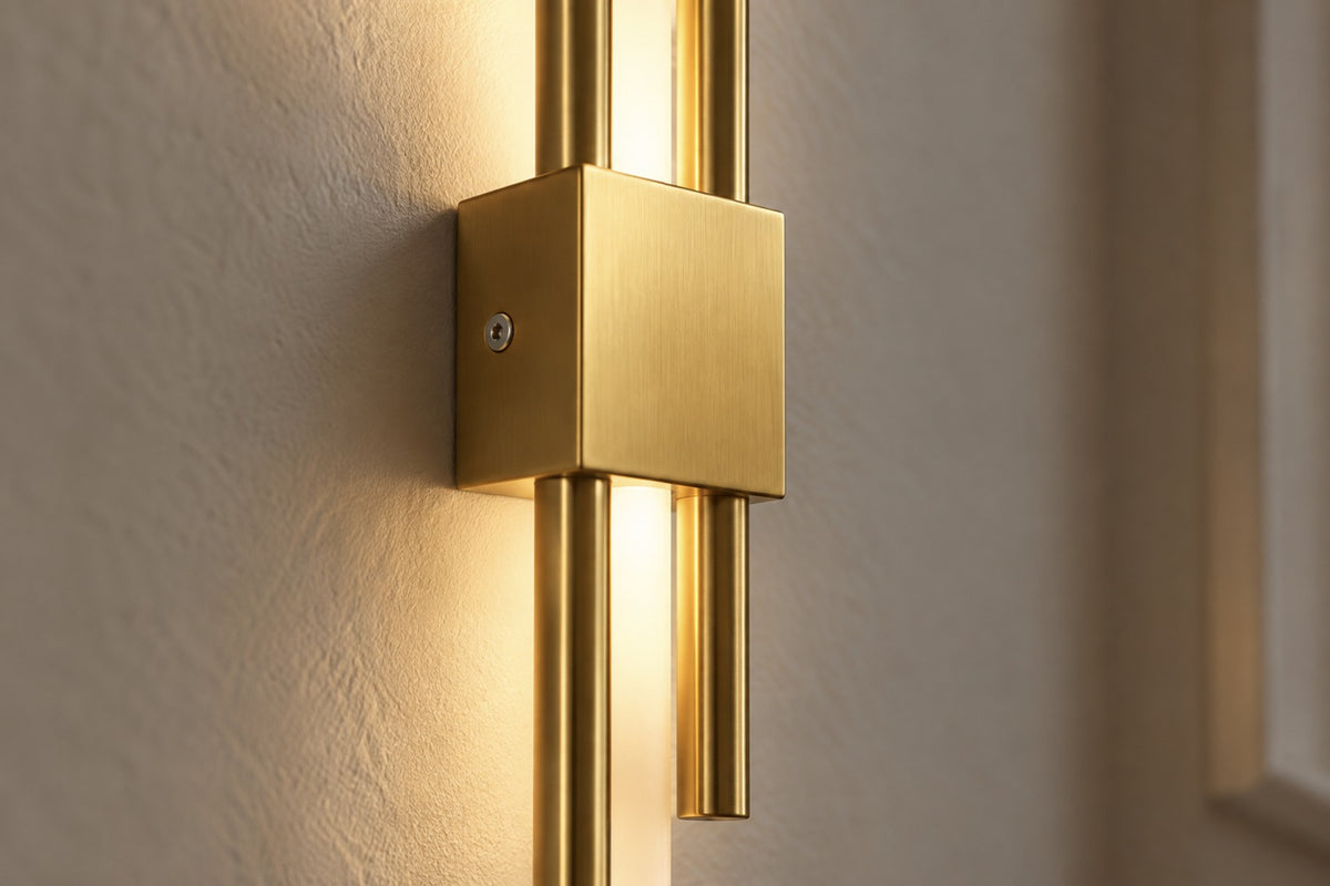 Close-up of the brushed gold rods and central block of the Lyra LED wall light