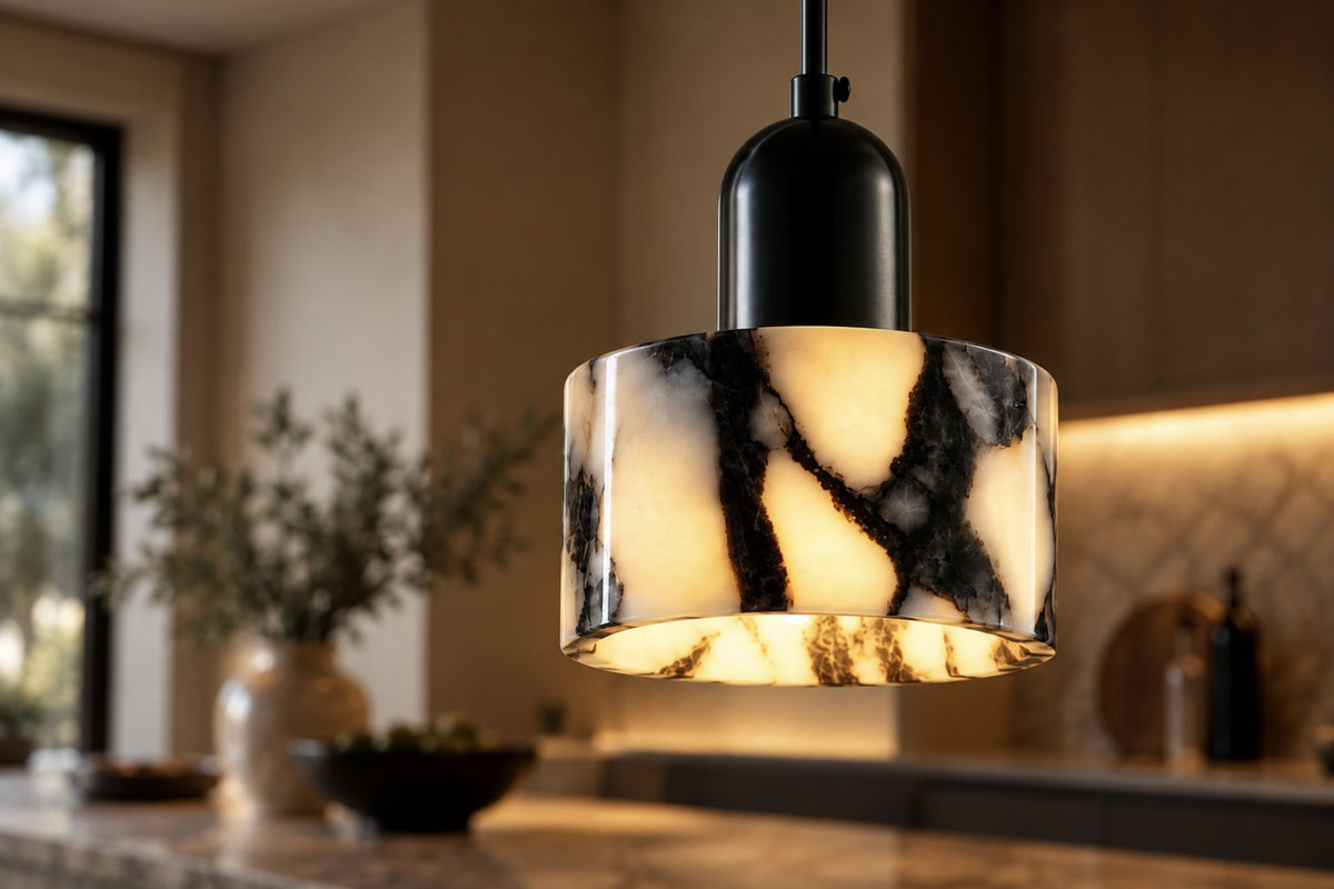 Close-up of the veined natural stone drum and black cap of the Marra pendant