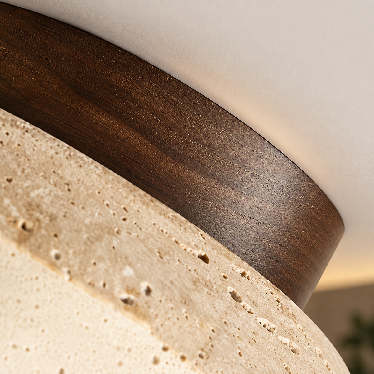 Close-up of the Siena travertine texture and walnut-tone rim
