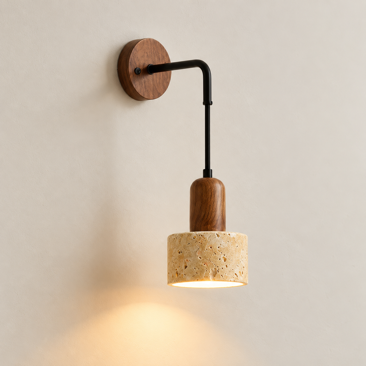Sora wall light with travertine shade, walnut-tone backplate and black arm, lit