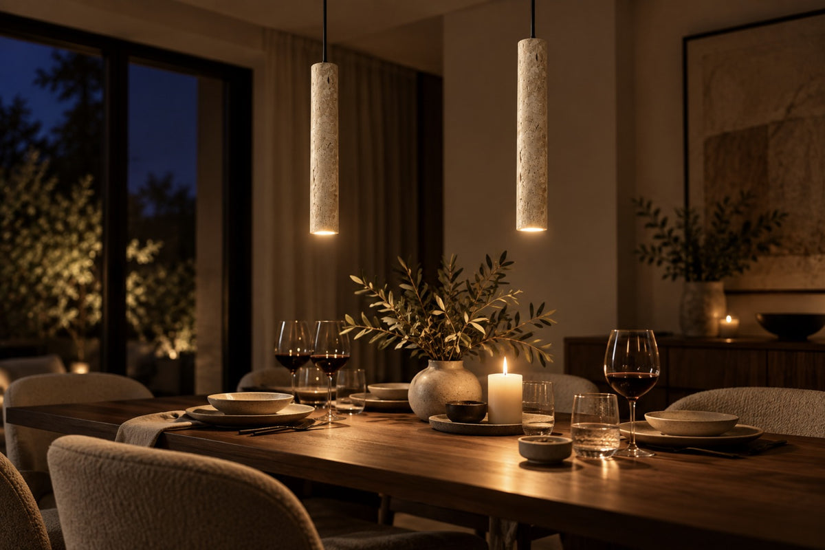 Two Sorelia stone pendants glowing above a dinner table at night