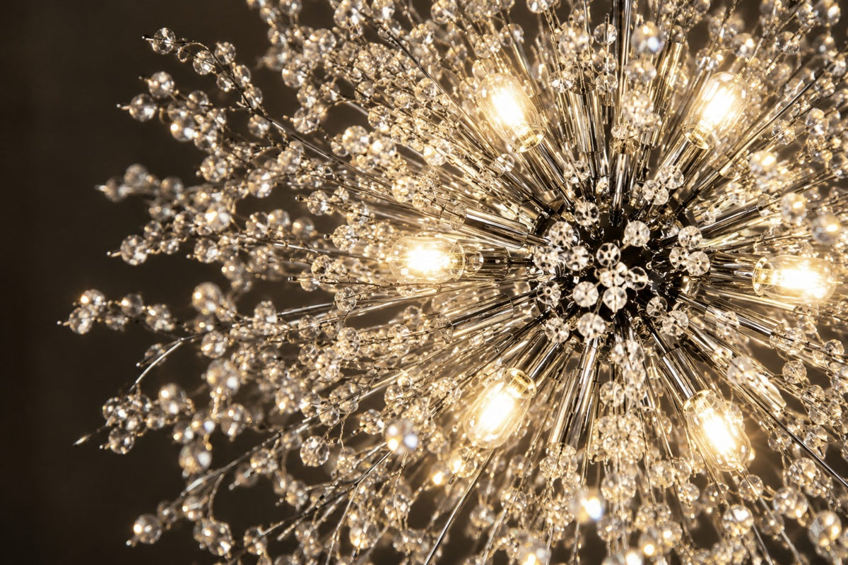 Close-up of the Stellia chandelier's crystal-tipped chrome rays and glowing bulbs