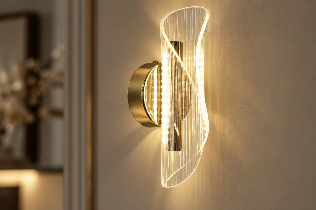 Close-up of the Velia ribbed acrylic scroll and gold base, lit