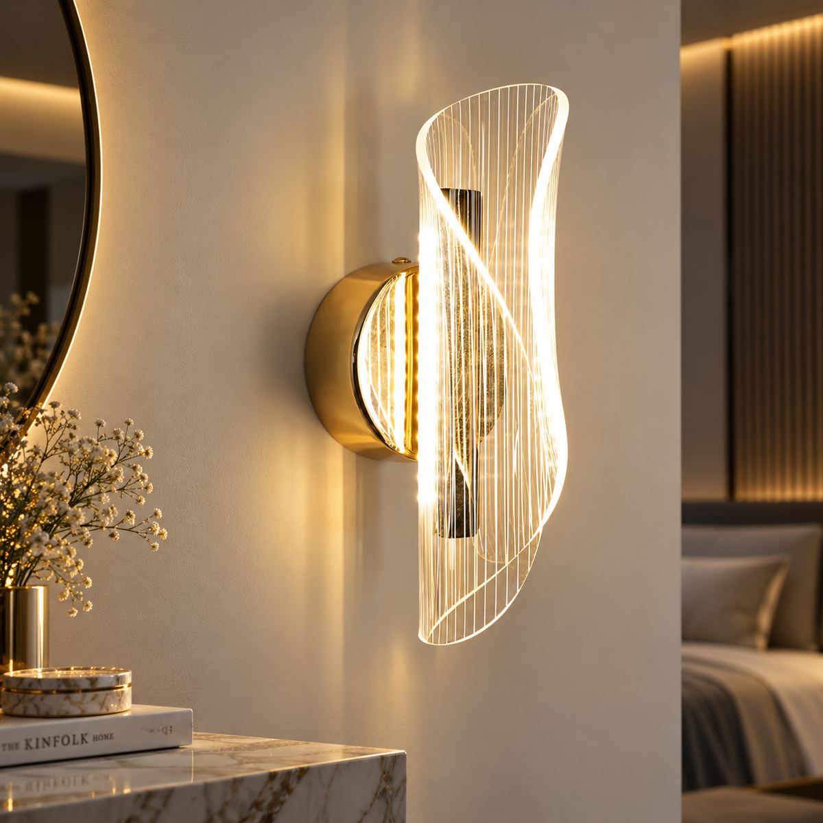 Velia gold and acrylic LED wall light glowing warm white