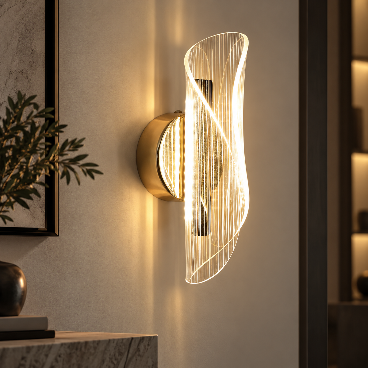 Velia gold and acrylic LED wall light on a living room wall