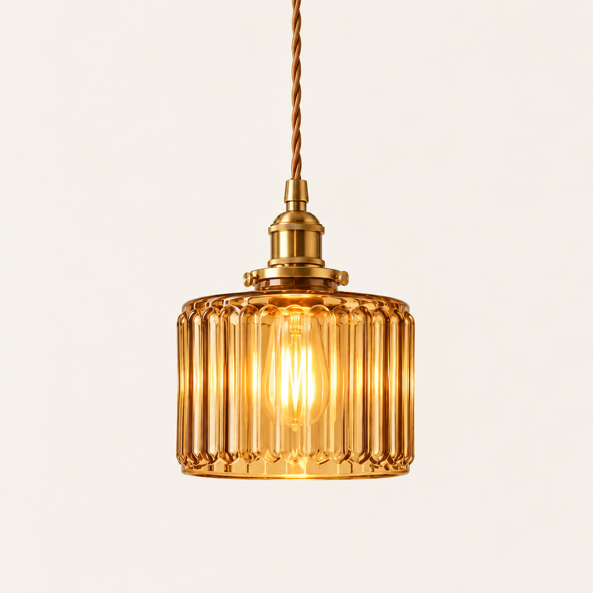 Verra ribbed glass pendant light in amber glass with a brass holder